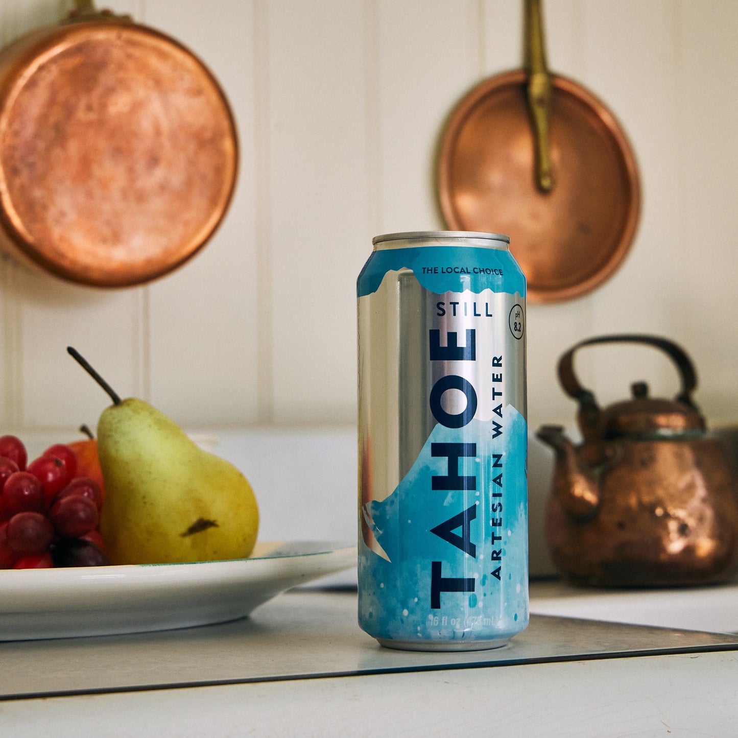 
                  
                    Tahoe water can on a kitchen counter with fruits and pots in the background
                  
                