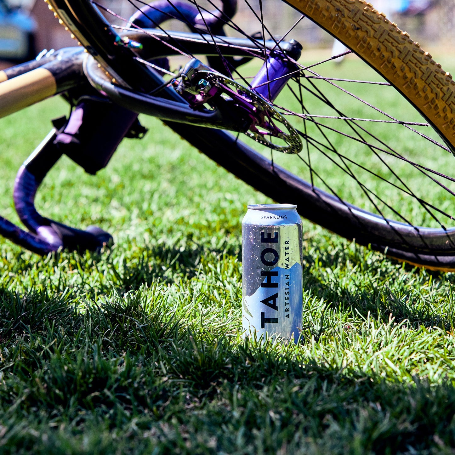 
                  
                    Bicycle on grass with a can of Tahoe artesian water nearby
                  
                